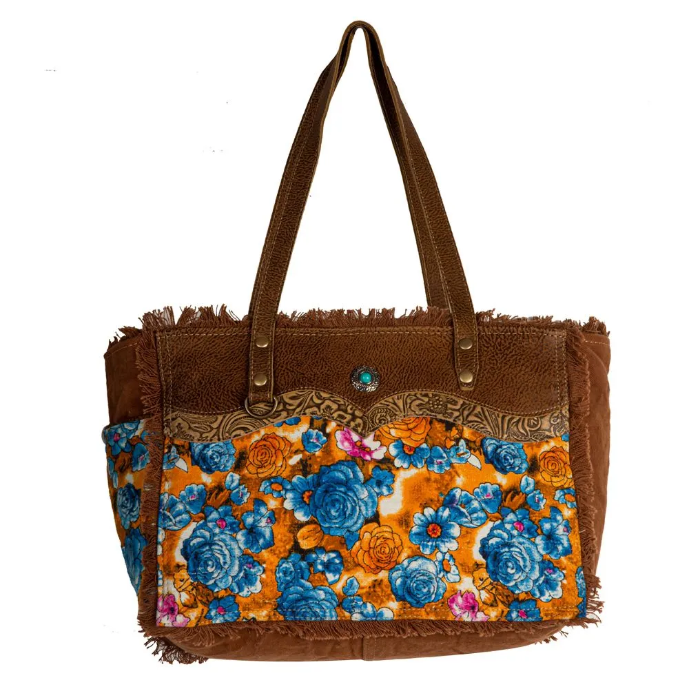 Myra Bag Blue Ridge Blossoms Crossbody: Vibrant Woven Rug, Hand-Tooled Leather, and Frayed Edge Accents